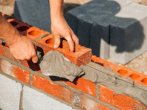 Ouvriers en bâtiment travaillant sur un chantier de construction extérieur